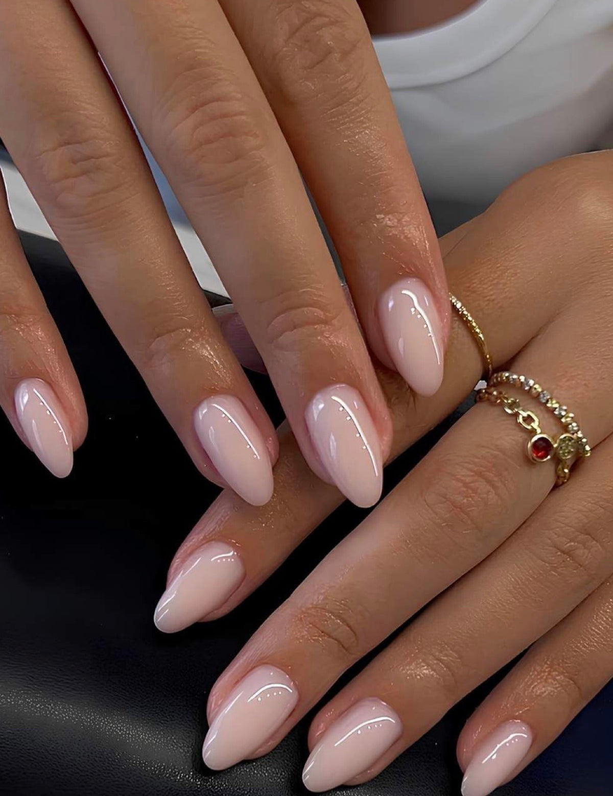 almond shaped medium length press on nails on a baby pink color very soft natural and elegant manicure
