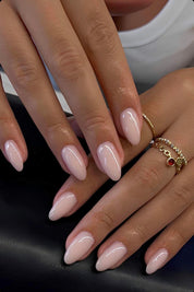 almond shaped medium length press on nails on a baby pink color very soft natural and elegant manicure